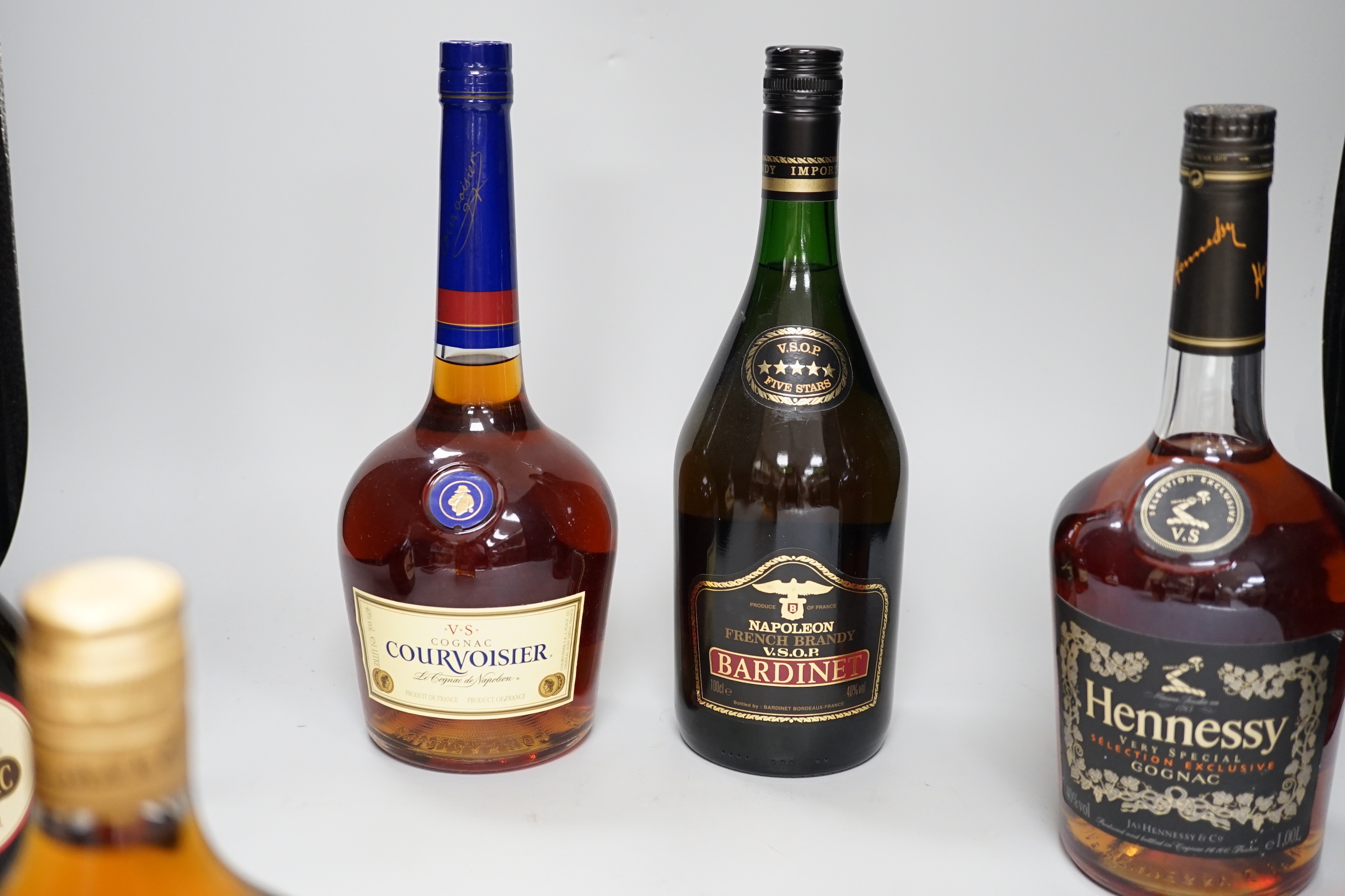 Five bottles of cognac, Armagnac and brandy - 1 litre of Hennessy very special selection exclusive cognac, 1 litre of VS Courvoisier cognac, 1 litre of VSOP Bardinet napoleon brandy, a 70cl bottle of Marquis de Senac Arm